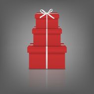 Stack of three realistic red gift boxes with white ribbon