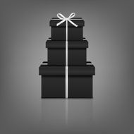Stack of three realistic black gift boxes with white ribbon