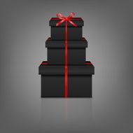 Stack of three realistic black gift boxes with red ribbon