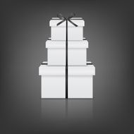 Stack of three realistic white gift boxes with black ribbon