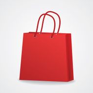Realistic red shopping bag with rope handles on grey background