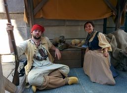 People in costumes on the market in the museum of archeology and history pointe-Ã -calliÃ¨re