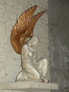 Statue of angel figure with bronze wings