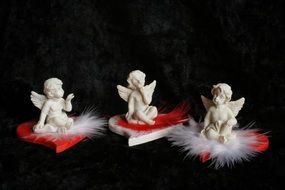 sitting angels on red hearts miniatures