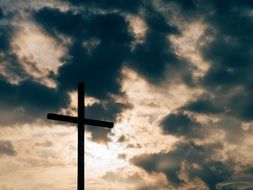 cross on the summit of alps mountain peak, symbol of christianity