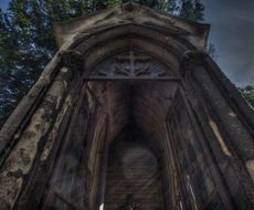 aged christian tombstone on montmartre cemetery, france, paris