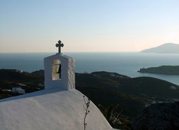 white cross on the roof of the church