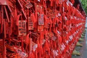 lot of wishes written on mini red boards at temple
