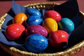 colored Easter eggs in a wicker basket