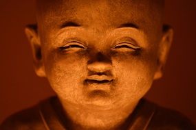 smiling buddha face statue