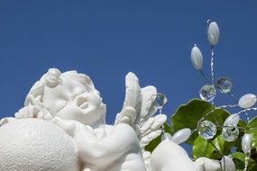 white sleeping angel statue in a garden