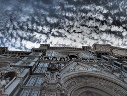 Cathedral of Saint Mary of the Flower, part of facade at cloudy sky, bottom view, italy, florence