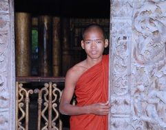 monk at the pillar of the temple in Myanmar