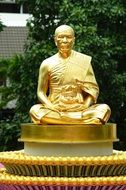 Gold statue of budha monk in the temple