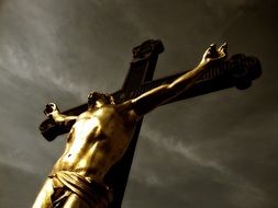 jesus on the cross against a cloudy sky