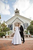 Wedding of bride and groom on the background of a church