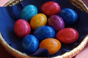 colored eggs in a wicker basket