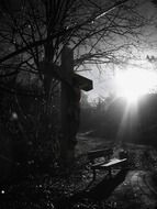cross and wooden bench
