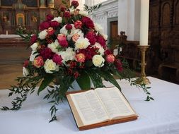 bible and wedding bouquet on altar