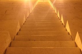 sun rays illuminate the stairs in the temple