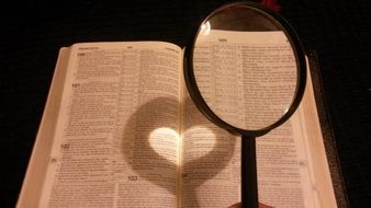 magnifying glass over an open book