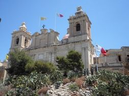 church with flags in Malta