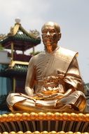 gold statue of budha monk buddhism