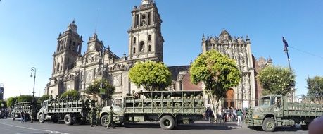 army trucks with soldiers at cathedral, mexico