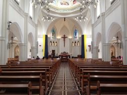 wooden lacquered benches in a catholic temple