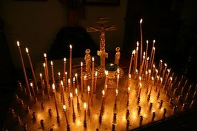 Photo of Lighting church candles in a dark
