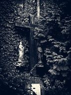 Cross next to the saints on the wall in a gloomy evening