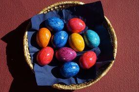 colored eggs on a blue napkin for Easter