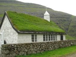 landscape of grass roof on a small chapel and hill