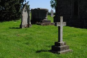 tombstones and stone cross in a cemetery