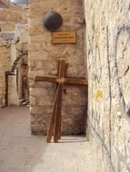 wooden crosses at aged stone wall, israel, holy land