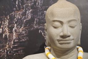 stone buddha statue with closed eyes
