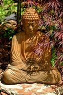 A statue of a golden buddha in the garden