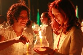 women on the ceremony with the candles