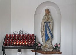 Mary sculpture and burning candles