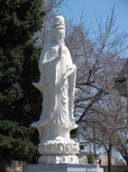 white statue in front of Truc Lam Temple in Chicago