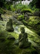 Green Buddha statues on hill side, japan, Kumamoto