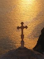 cross on a church at sunset