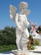 statue of a child with wings in a cemetery