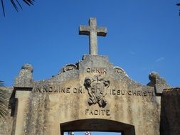 ancient stone wall with cross, place of pilgrimage