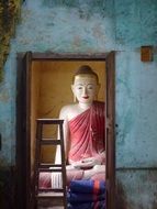 the monk sits by the mirror