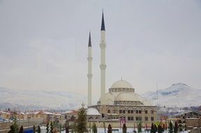 photo of mosque on a background of mountains