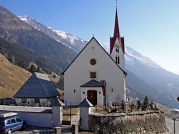 church with steeple at scenic mountains, austria, east tyrol