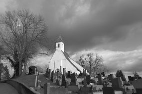 church in a cemetery in black and white image