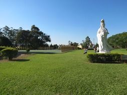 statue of a large white buddha in a park in sao paulo in brazil