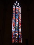 large stained glass window on a black background, ulm cathedral